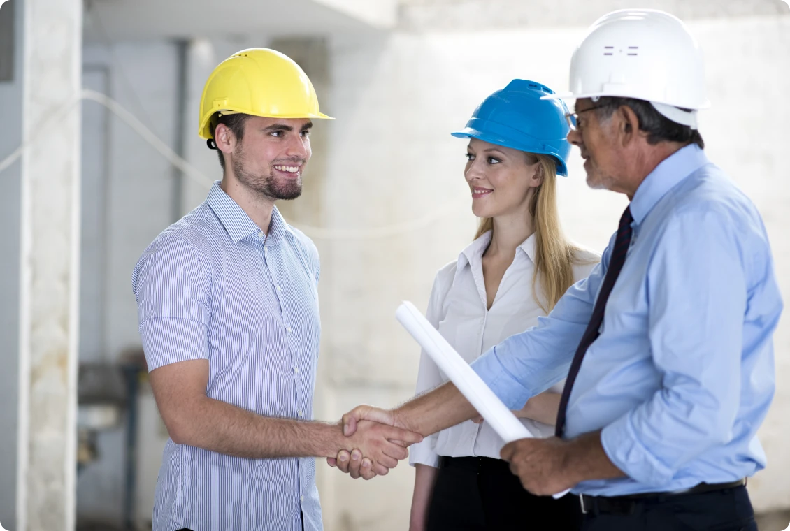 Colleagues wearing safety helmets in discussion
